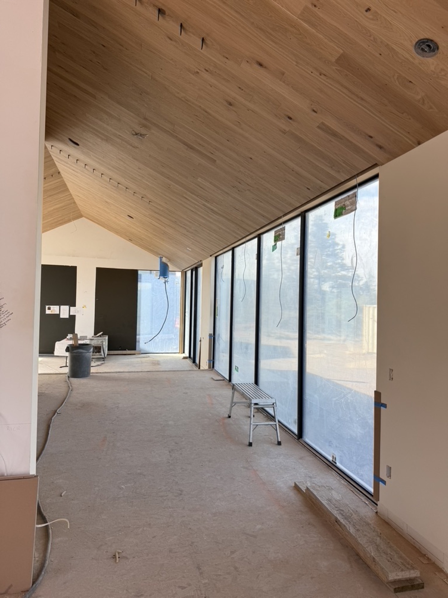 Vaulted wood ceiling meeting a wall of windows